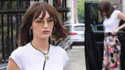 Somber Bella Hadid braves the rain in patchwork trousers... hours after sister Gigi's shock split from Zayn Malik.
