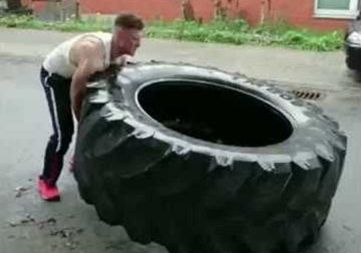 Impressively Strong Man Continuously Flips Giant Tire Along Road