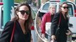 Angelina Jolie showcases her off-duty style in a chic wrap coat and stiletto boots as she takes her children to watch the new Tomb Raider reboot.