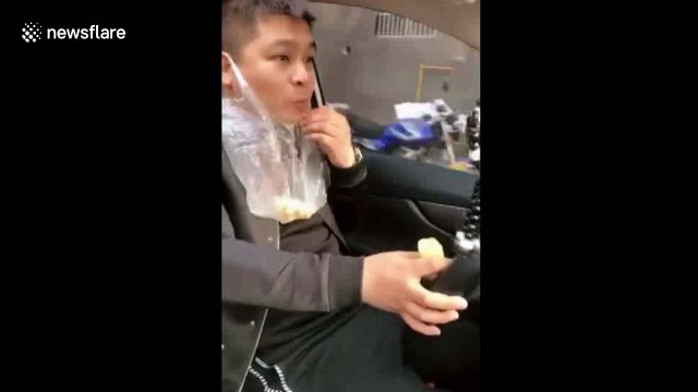 Driver heaves food waste into plastic bag wrapped around his ear