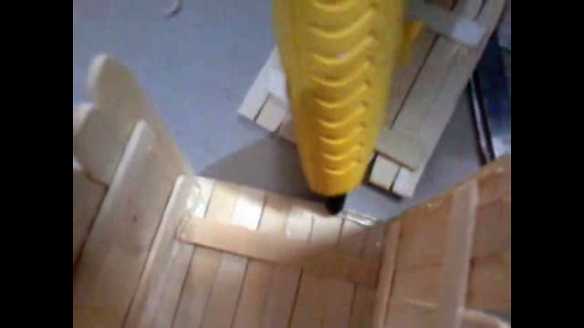 two models of pen stand - one using Popsicle sticks, other using news paper roll