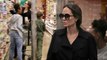 An average mom! Angelina Jolie picks up oatmeal at Whole Foods in Los Angeles with Zahara and Knox... as divorce from Brad Pitt is still not finalized.