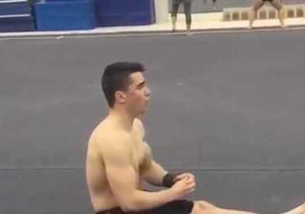 Gymnast Effortlessly Executes Sitting Back Flip