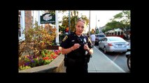 Officer confronted after threatening to strike photographer..-