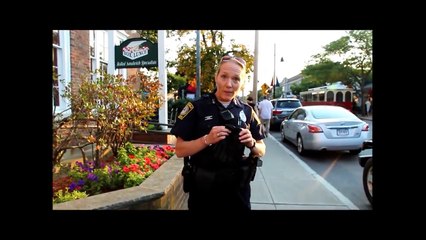 Officer confronted after threatening to strike photographer..-