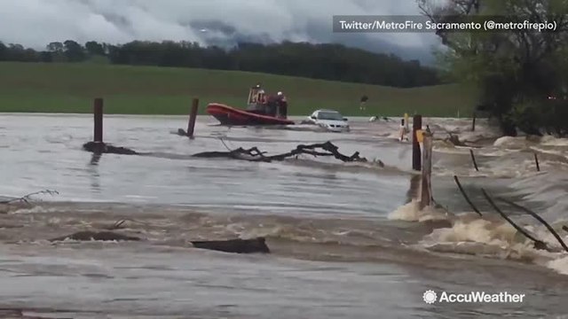 Firefighters rescue man stranded on car during flash flood