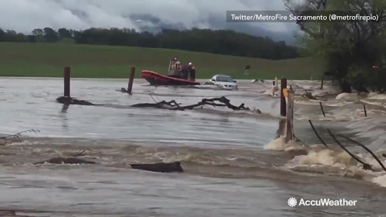 Firefighters rescue man stranded on car during flash flood