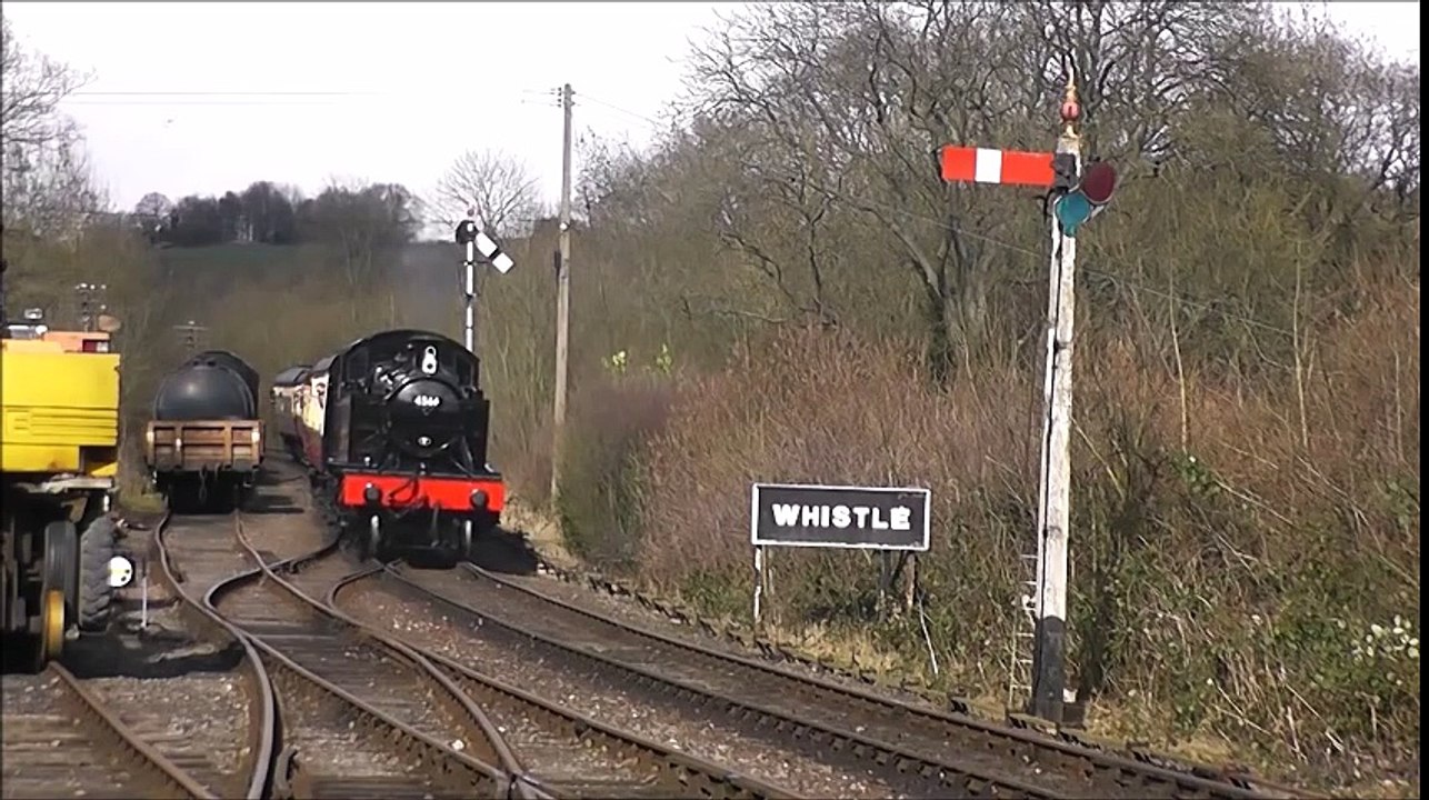 Railway Signal Drops to let Incoming Steam Locomotive approach Train Station