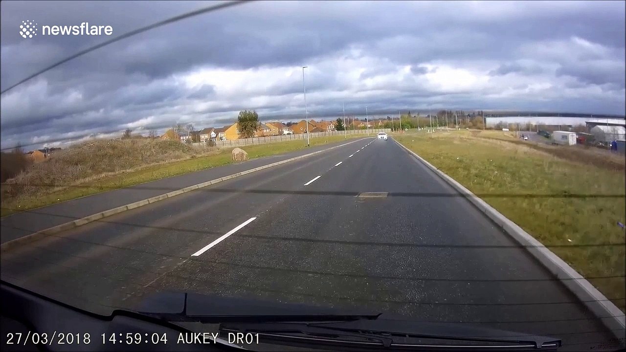 BMW overtakes learner driver on wrong side of UK roundabout