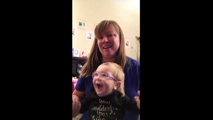 Baby sees cat for first time with glasses. Clip baby