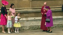 Adorable! Queen is given Easter bouquets by two little girls