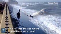 Dramatic footage shows four people in the UK were rescued from sea by human chain.