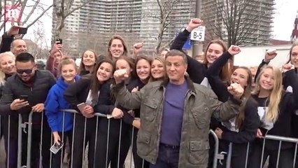 Sylvester Stallone poses under Rocky statue in Philadelphia and meets fans
