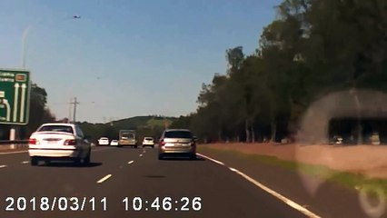 man turns around on a highway and collides with a car