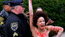 Topless woman charges past Bill Cosby at assault retrial