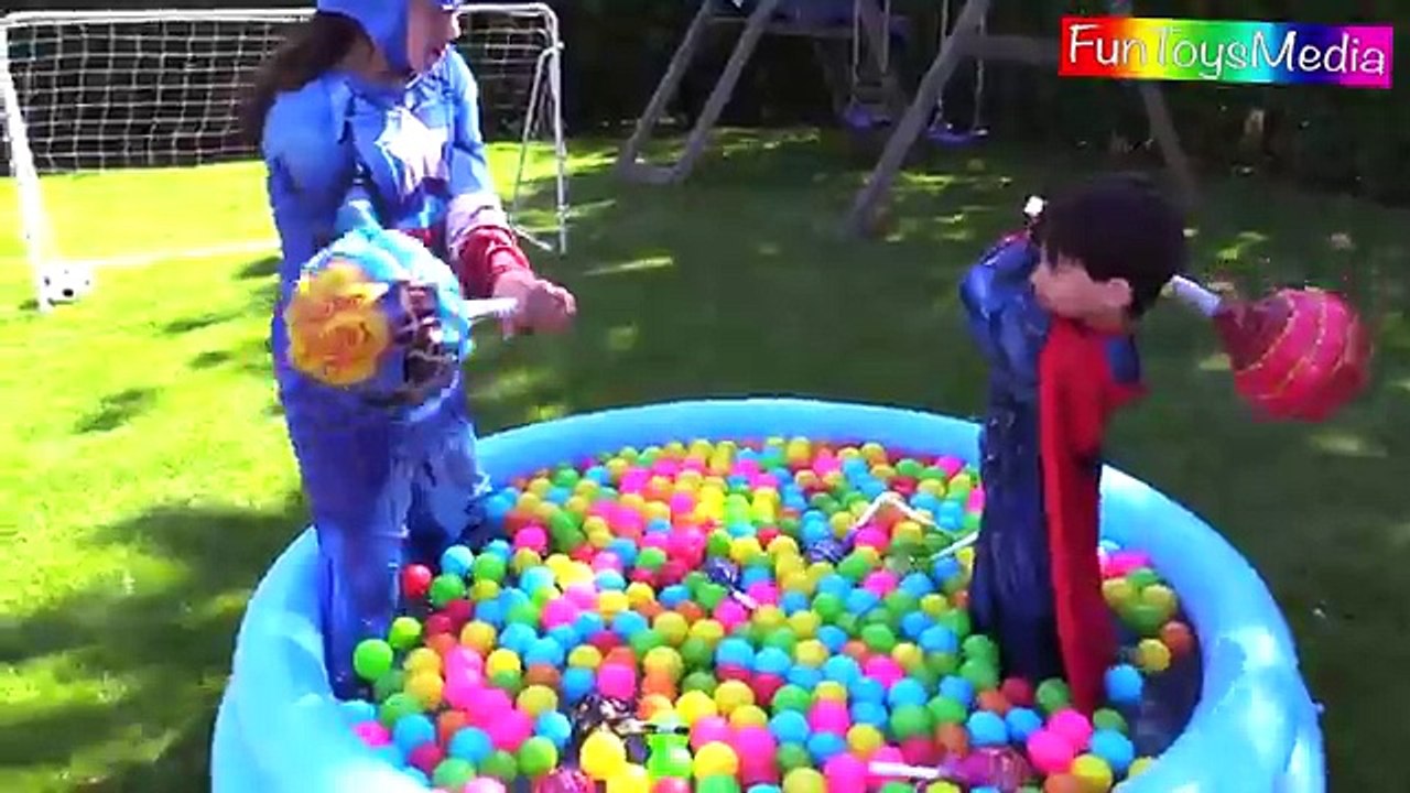 Big Lollipop Ball Pit Pool Race for Kids in Outdoor Play Area Playing Superman and Captain America