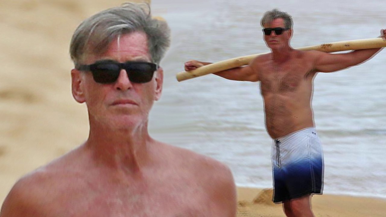 Pierce-Brosnan-64-perfects-his-posture-with-some-driftwood-as-he-goes-shirtless-on-the-beach-in-Hawaii