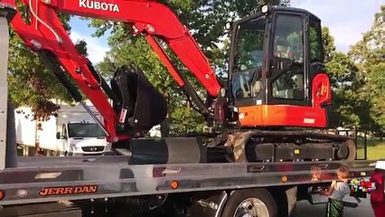 Kid Operating The Kubota Mini Excavator KX057-4 And The Rollback