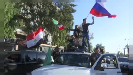Syrians gather along the streets of Damascus to condemn the air strikes