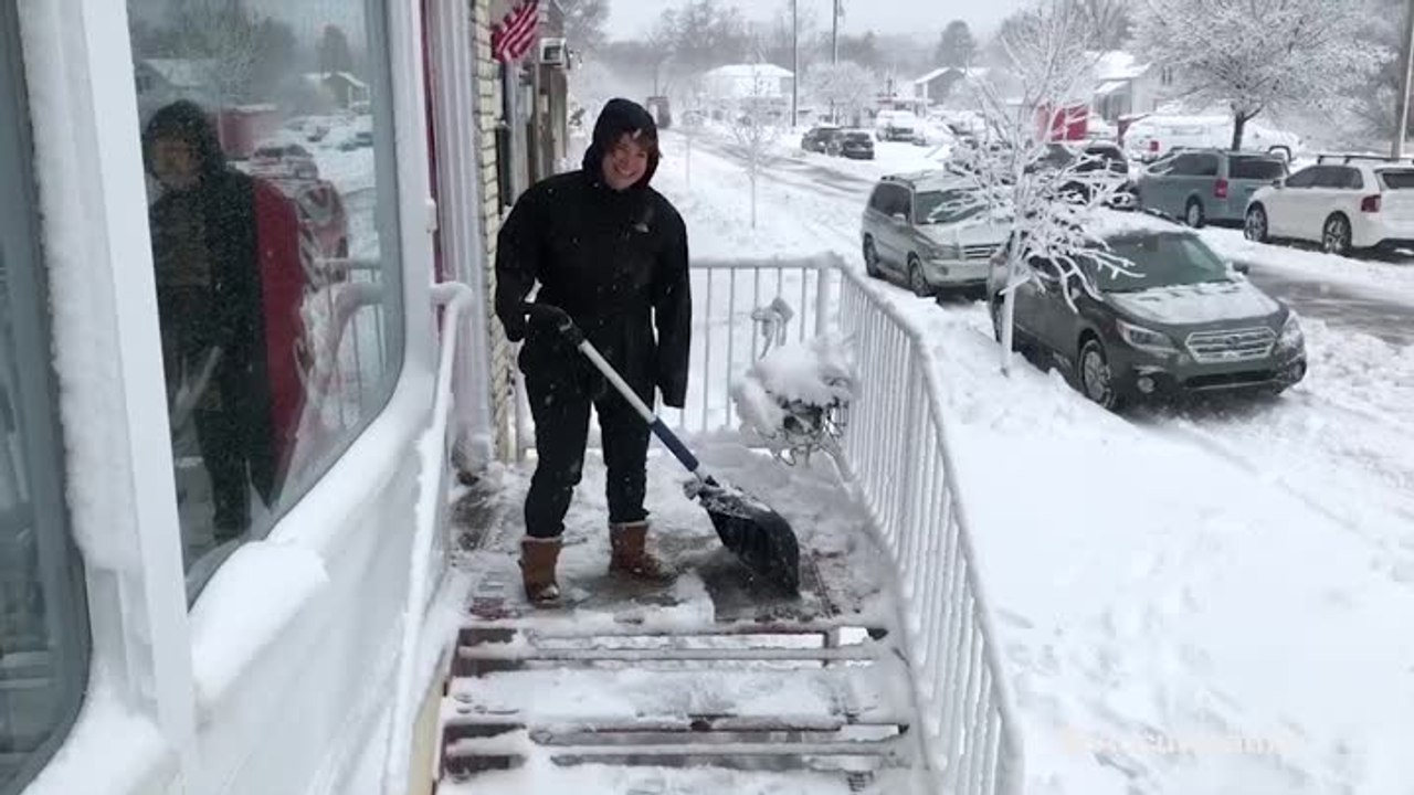 Early risers dig out after spring snowstorm in Michigan