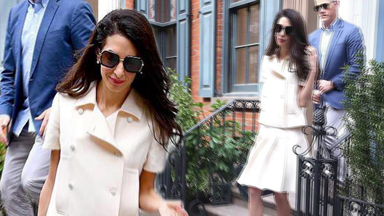 Amal Clooney looks demure in a chic cream jacket and pleated skater skirt as she steps out in New York.