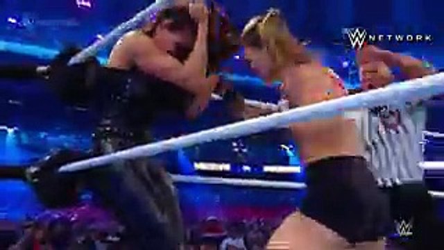 ROUSEY VICTORIOUS AT WRESTLEMANIA. In her WWE in-ring debut, Ronda Rousey lands a fury of punches to both Stephanie McMahon and Triple H. Rousey, alongside Kurt Angle, would go on to win the match.