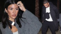 Kourtney Kardashian gives a glimpse of her taut abs in a sporty grey crop top as she joins boyfriend Younes Bendjima at Coachella's Neon Carnival.