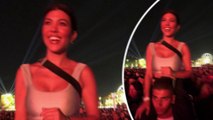Kourtney Kardashian sits on boyfriend Younes' shoulders to watch Beyonce perform at Coachella.