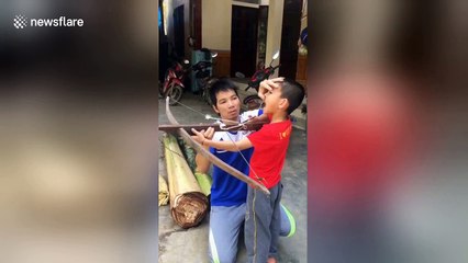 Boy uses crossbow as creative way to remove loose tooth