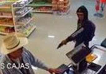 Man in Cowboy Hat Wrestles Gun Away From Man Holding Up Butcher's Shop