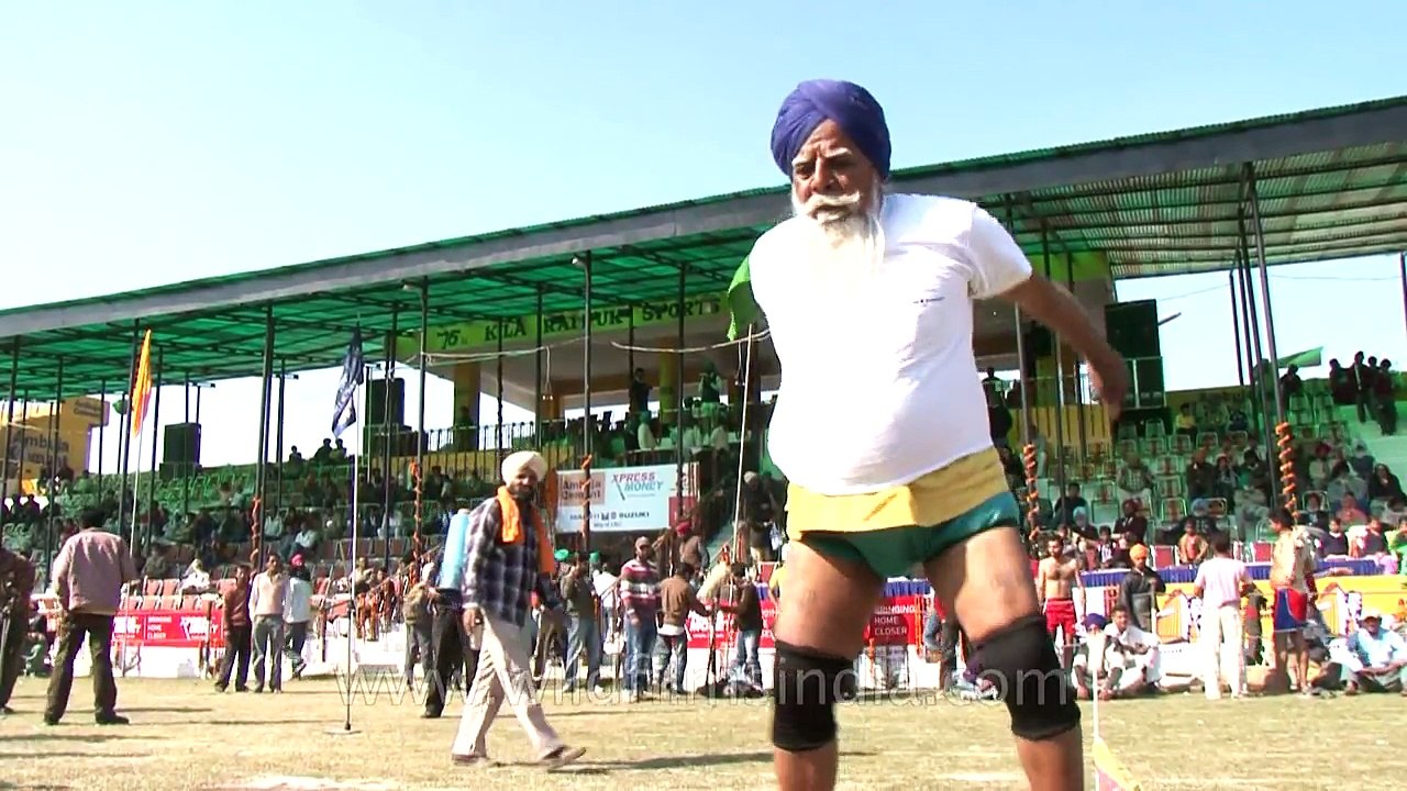 Old man Hulk lifts a heavy weight at Kila Raipur Rural Olympics