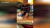 Chinese man nonchalantly slices up jelly noodles at speed with massive cleaver