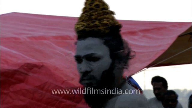 A young sadhu with his face and body smeared with ash at Varanasi