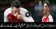 German Muslim footballer Mesut Ozil kisses bread thrown at him by Atletico Madrid fans