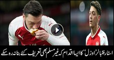 German Muslim footballer Mesut Ozil kisses bread thrown at him by Atletico Madrid fans