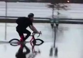 Bicyclist Navigates Floodwater Along St John River