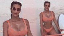 Kim Kardashian is a dream in tangerine as she posts sultry bikini vacation snap after visiting True.