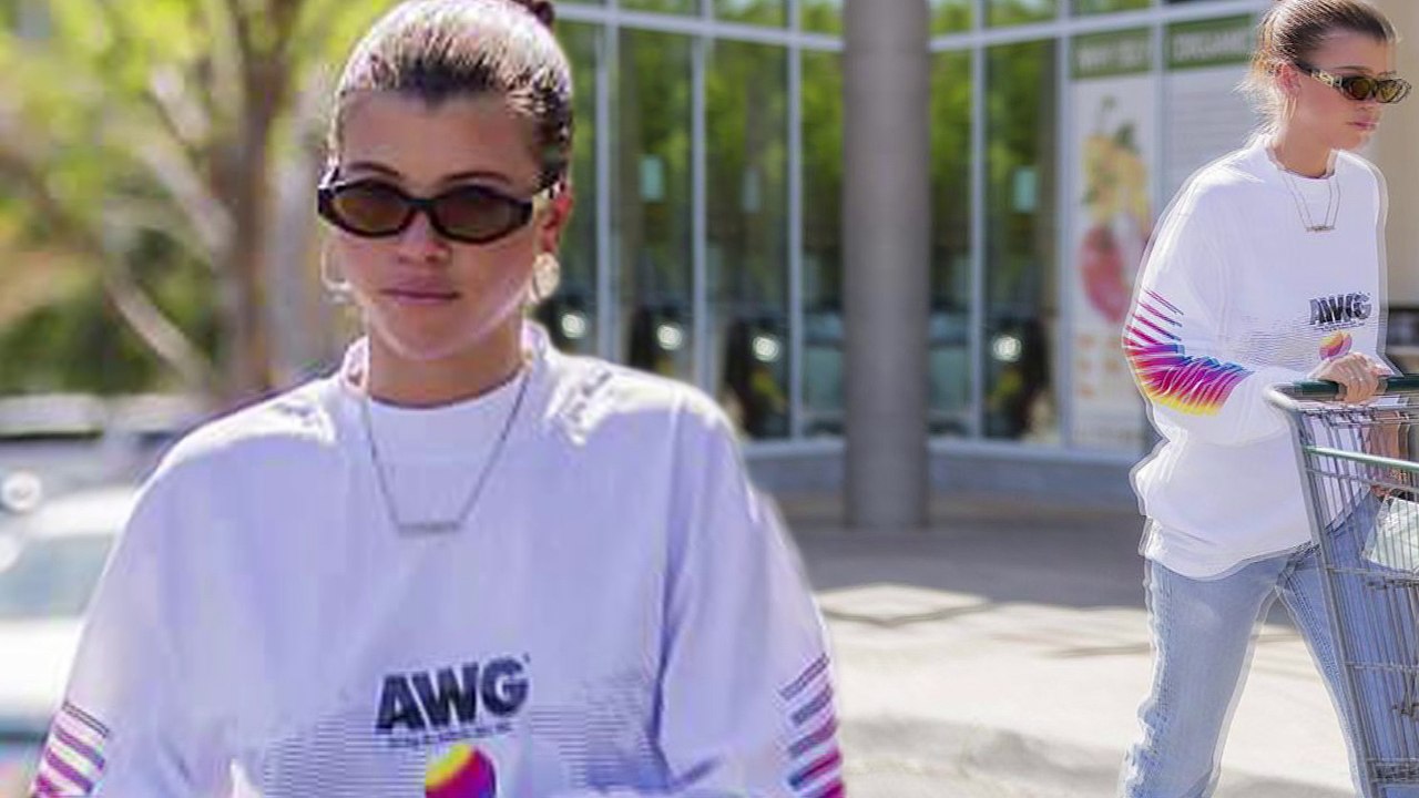 Sofia Richie models shades and high-heeled boots as she shops at Los Angeles health food market.