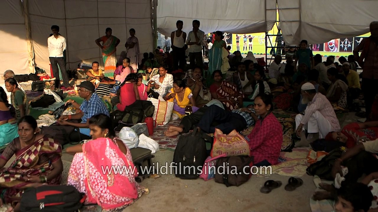 Crowd waits anxiously for the miracle process of fish remedy to begin