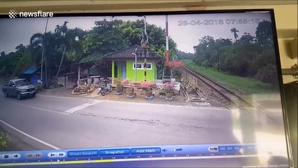Motorcyclist clotheslined by level crossing moments before train passes
