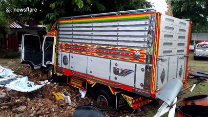 Truck skids off road and crashes during heavy rain