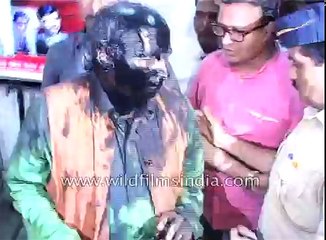 Indian form of protest- blacken mans' face with oil