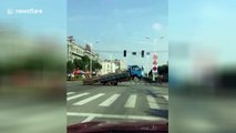 Overloaded lorry seesaws onto its back wheels