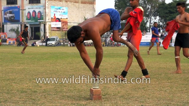 Physically challenged man balances himself atop a bottle - only in India
