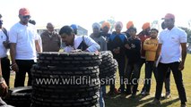 Indian Tyre man hoists hundreds of kilograms of truck tyres onto himself