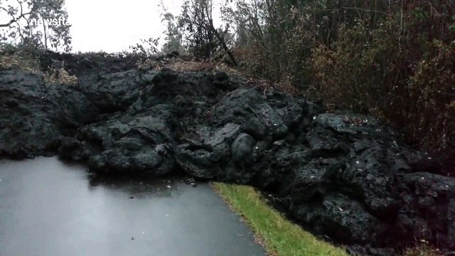 Wall of cooling black lava blocks street in Hawaii