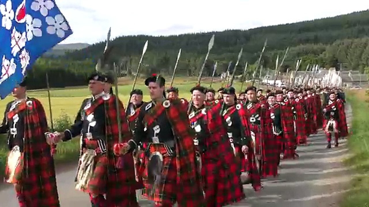 2016 Lonach Highlanders march through Strathdon Scotland together with the Atholl Highlanders