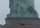 Helicopter Hovers as Woman Climbs Statue of Liberty
