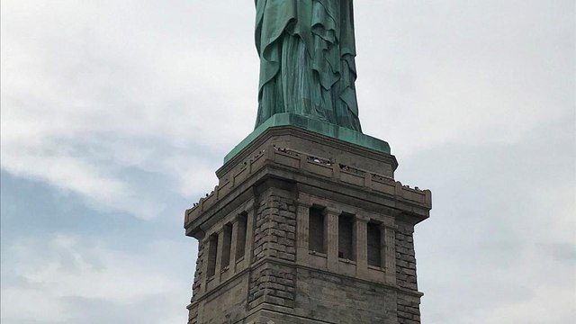 Watch: protester removed from Statue of Liberty after immigration demo