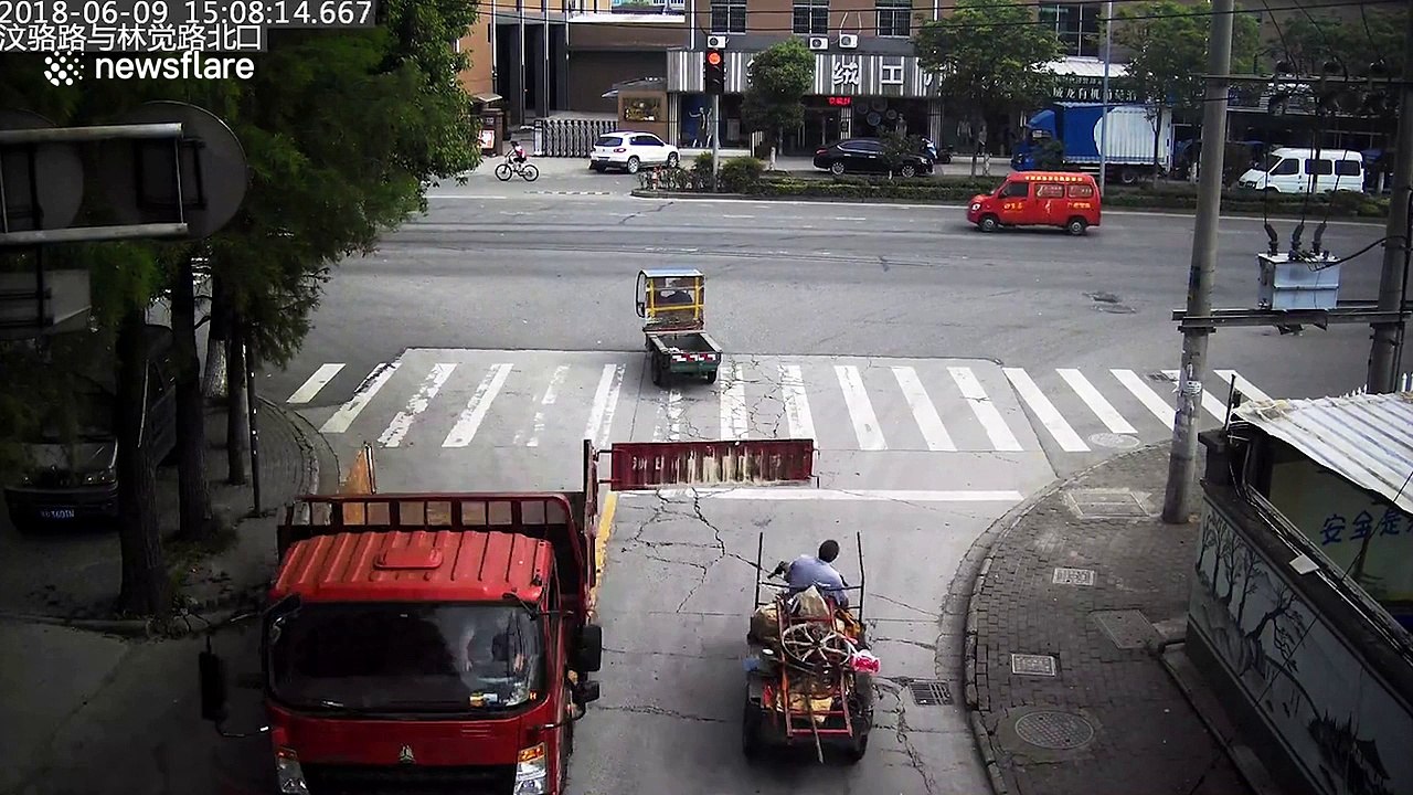 Back of truck swings open and hits three-wheeler driver on the head